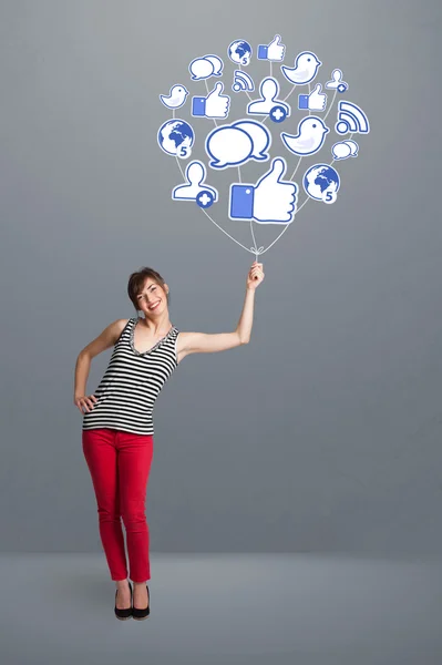 Pretty woman holding social icon balloon — Stock Photo, Image