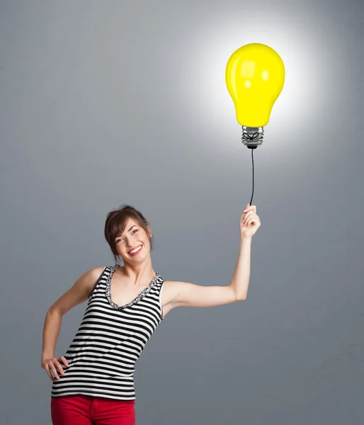 Pretty lady holding a light bulb balloon — Stock Photo, Image