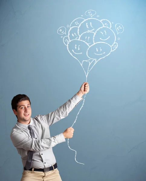 Hombre feliz sosteniendo globos sonrientes dibujo —  Fotos de Stock