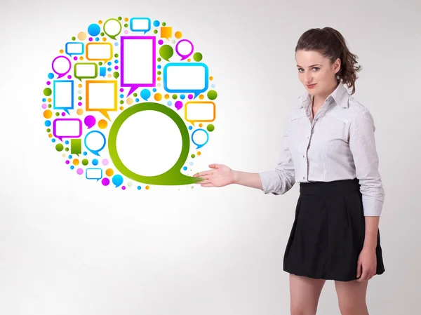 Young business woman presenting colourful speach bubble — Stock Photo, Image