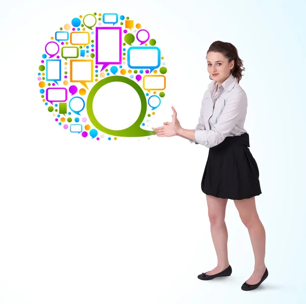 Young business woman presenting colourful speach bubble — Stock Photo, Image