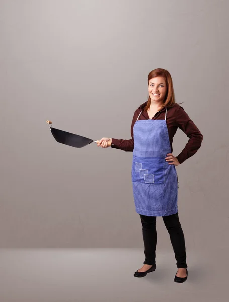 Young lady holding a frying pan — Stock Photo, Image