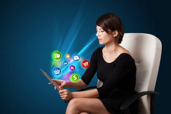 Young woman looking at modern tablet with abstract lights and va — Stock Photo, Image