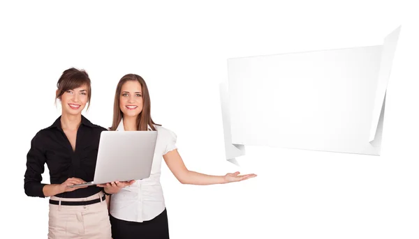 Young women presenting abstract origami copy space — Stock Photo, Image