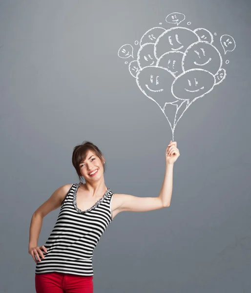 Mujer feliz sosteniendo globos sonrientes dibujo —  Fotos de Stock