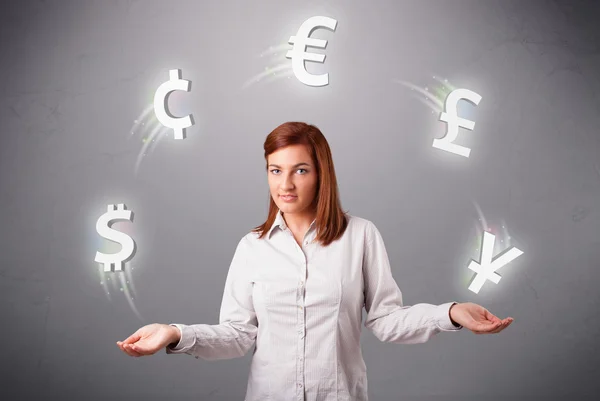 Young lady standing and juggling with currency icons — Stock Photo, Image