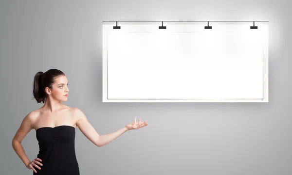 Young woman presenting modern copy space — Stock Photo, Image