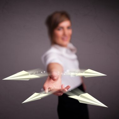 Origami uçaklarını fırlatan güzel bayan.