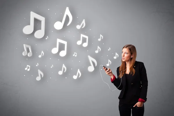 Jolie jeune femme chantant et écoutant de la musique avec n musical — Photo