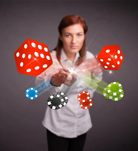 Young woman throwing dices and chips — Stock Photo, Image