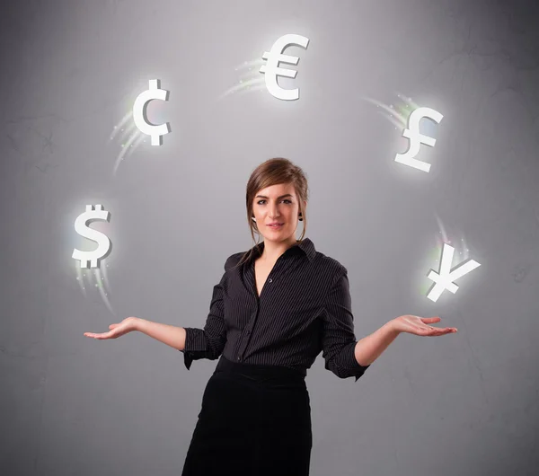 Young lady standing and juggling with currency icons — Stock Photo, Image