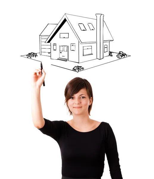 Young woman drawing a house on whiteboard — Stock Photo, Image