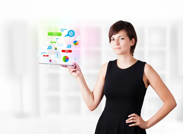 Young woman looking at modern tablet with colourful technology i — Stock Photo, Image