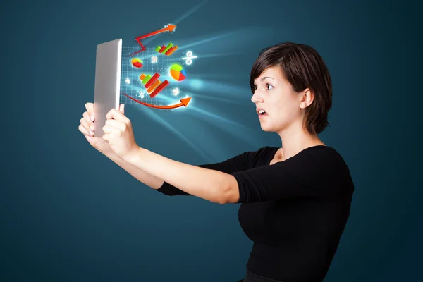 Young woman looking at modern tablet with abstract lights and va — Stock Photo, Image