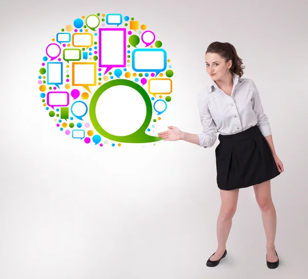 Young business woman presenting colourful speach bubble — Stock Photo, Image