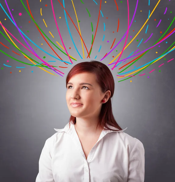 Young girl thinking with colorful abstract lines overhead — Stock Photo, Image