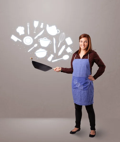 Mladá žena s ikonami kuchyňského příslušenství — Stock fotografie