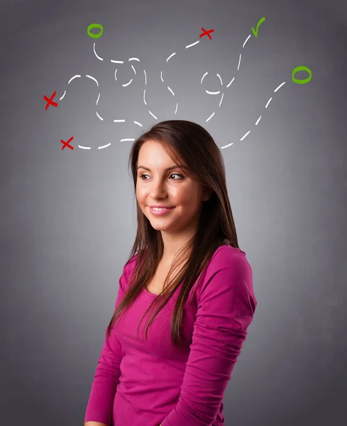 Młoda kobieta myśląca abstrakcyjnymi znakami nad głową — Zdjęcie stockowe