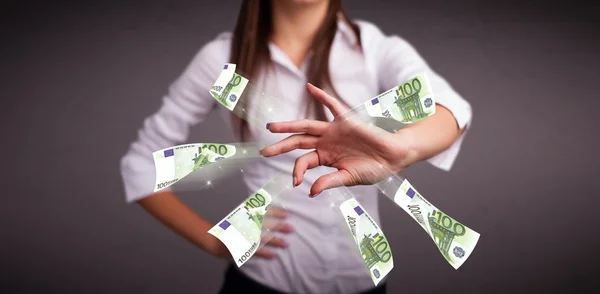 Pretty woman standing and throwing money — Stock Photo, Image