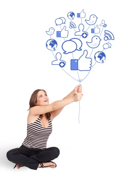 Happy lady holding social icon balloon — Stock Photo, Image