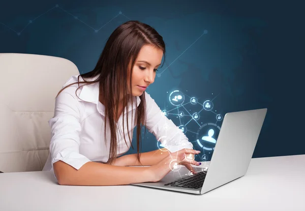 Fiatal hölgy ülő-on iskolapad és laptop-val társadalmi hálóz.Alapért gépelés — Stock Fotó