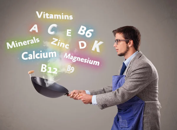 Man cooking vitamins and minerals — Stock Photo, Image