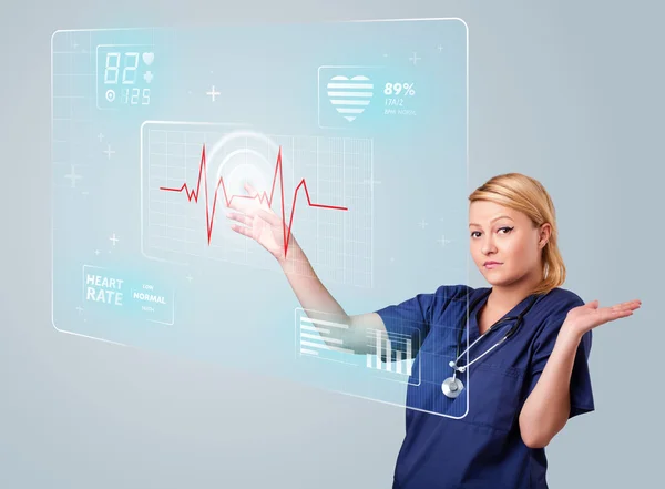 Young nurse pressing modern medical type of buttons — Stock Photo, Image