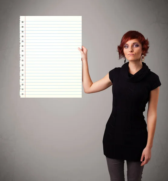 Young woman holding white paper copy space with diagonal lines — Stock Photo, Image