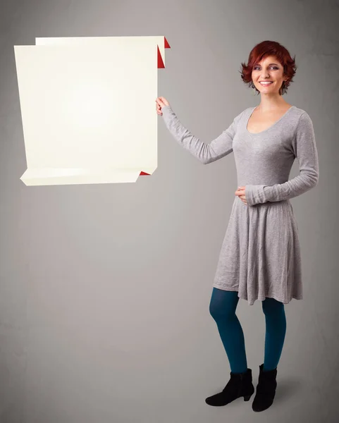 Young woman holding white origami paper copy space — Stock Photo, Image