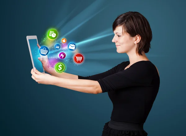 Young woman looking at modern tablet with abstract lights and va Stock Picture