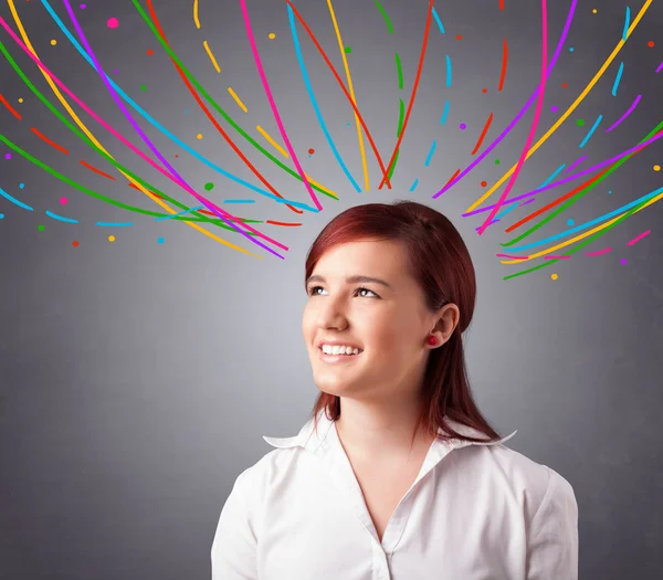 Young girl thinking with colorful abstract lines overhead — Stock Photo, Image