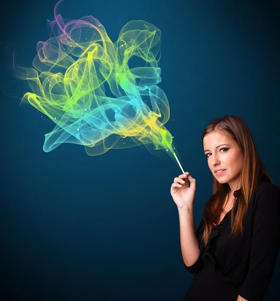 Pretty lady smoking cigarette with colorful smoke — Stock Photo, Image