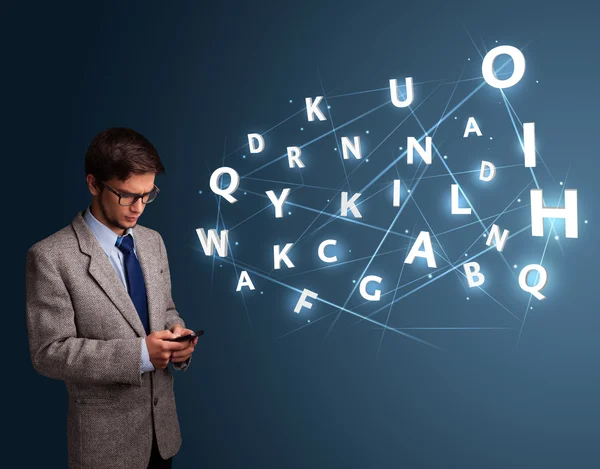 Young man typing on smartphone with high tech 3d letters comming — Stock Photo, Image