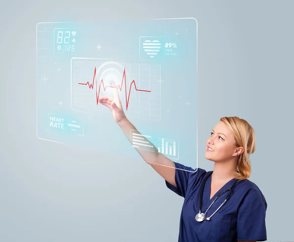 Young nurse pressing modern medical type of buttons — Stock Photo, Image