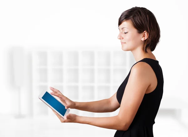 Young woman looking at modern tablet — Stock Photo, Image