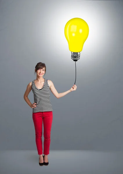 Pretty lady holding a light bulb balloon — Stock Photo, Image