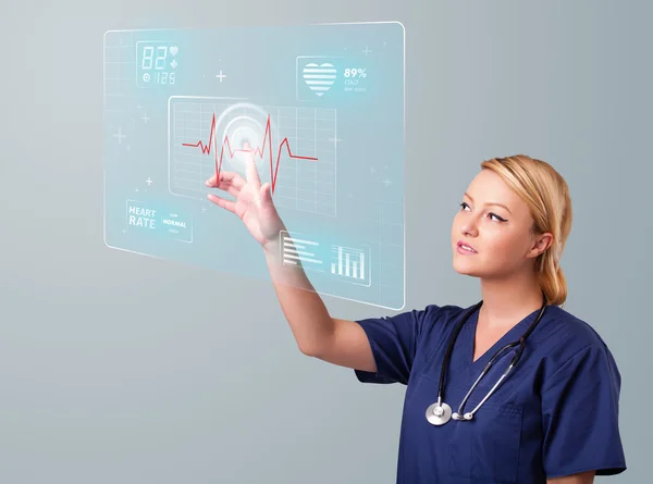 Young nurse pressing modern medical type of buttons — Stock Photo, Image