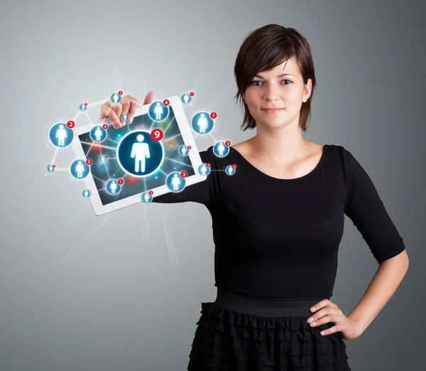 Young woman holding tablet with social network icons — Stock Photo, Image