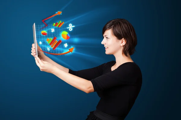 Young woman looking at modern tablet with abstract lights and va — Stock Photo, Image