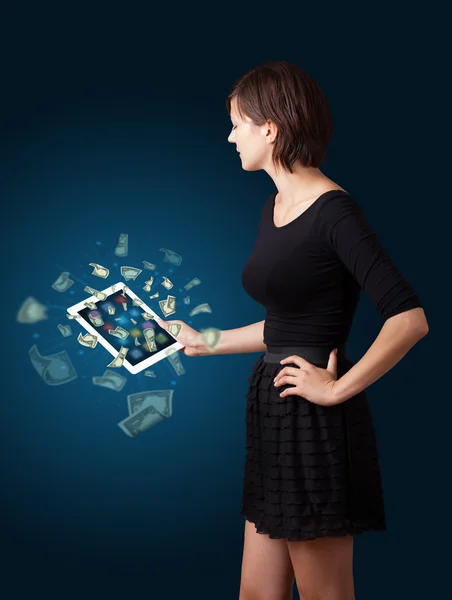 Young woman holding tablet with money — Stock Photo, Image