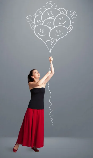 Donna felice che tiene sorridenti palloncini disegno — Foto Stock