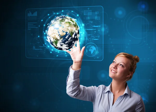 Young buinesswoman touching high-tech 3d earth panel — Stock Photo, Image