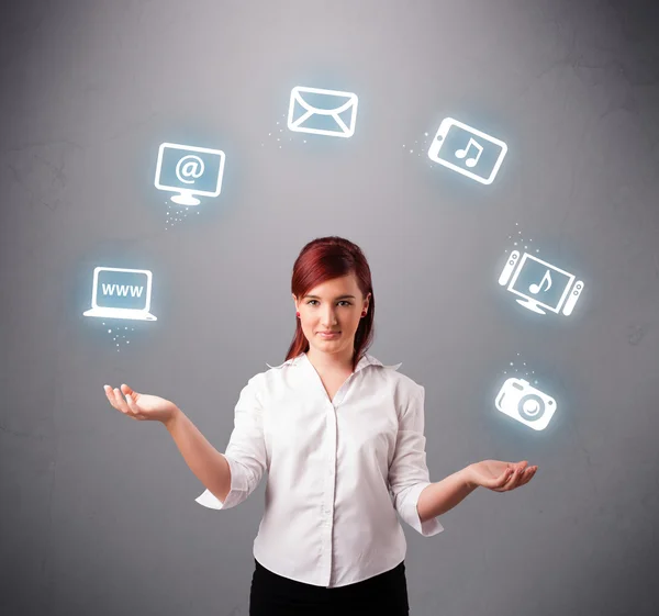 Pretty girl juggling with elecrtonic devices icons — Stock Photo, Image