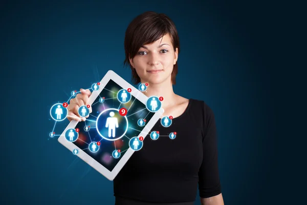 Young woman holding tablet with social network icons — Stock Photo, Image