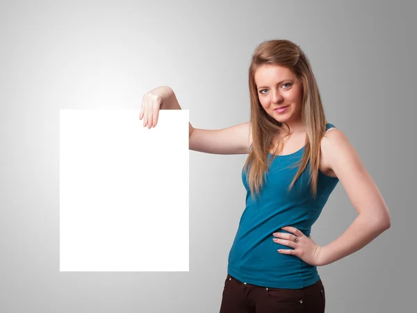 Young woman presenting white paper copy space — Stock Photo, Image