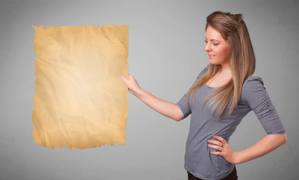 Young girl presenting old paper copy space — Stock Photo, Image