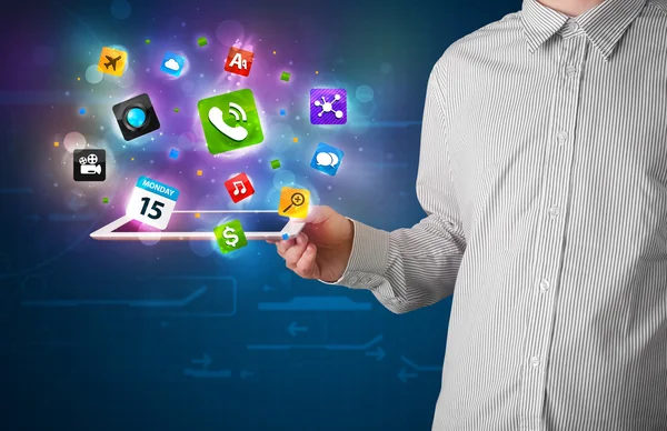 Businessman holding a tablet with modern colorful apps and icons — Stock Photo, Image