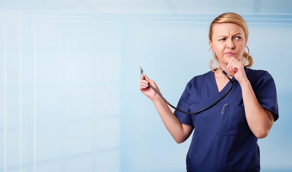 Enfermera bonita en el hospital escuchando espacio de copia vacía con la guadaña — Foto de Stock