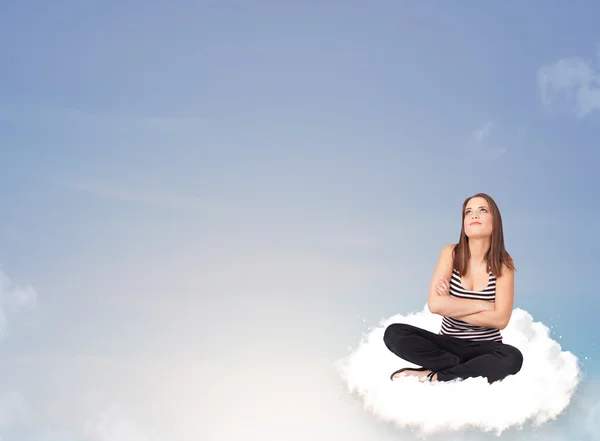 Young woman sitting on cloud with copy space — Stock Photo, Image