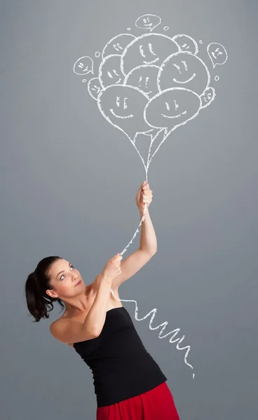 Mulher feliz segurando sorrindo balões desenho — Fotografia de Stock